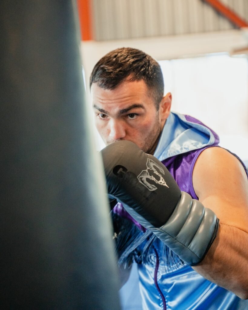 A man in a boxing ring with a punching glove
